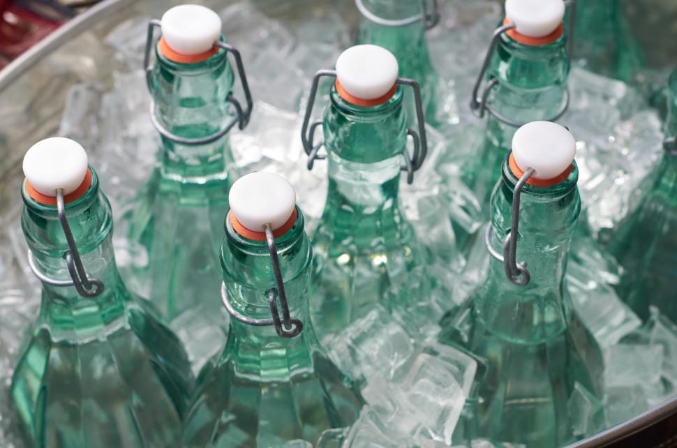 Free Image of A group of green bottles with white caps 