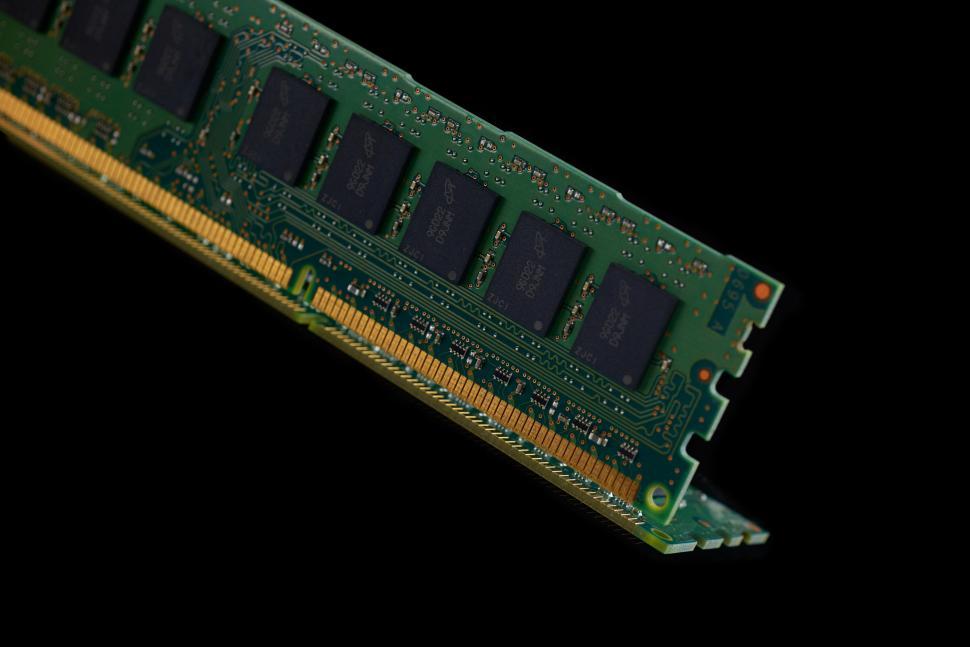 Free Image of A green computer chip with gold and black chips 