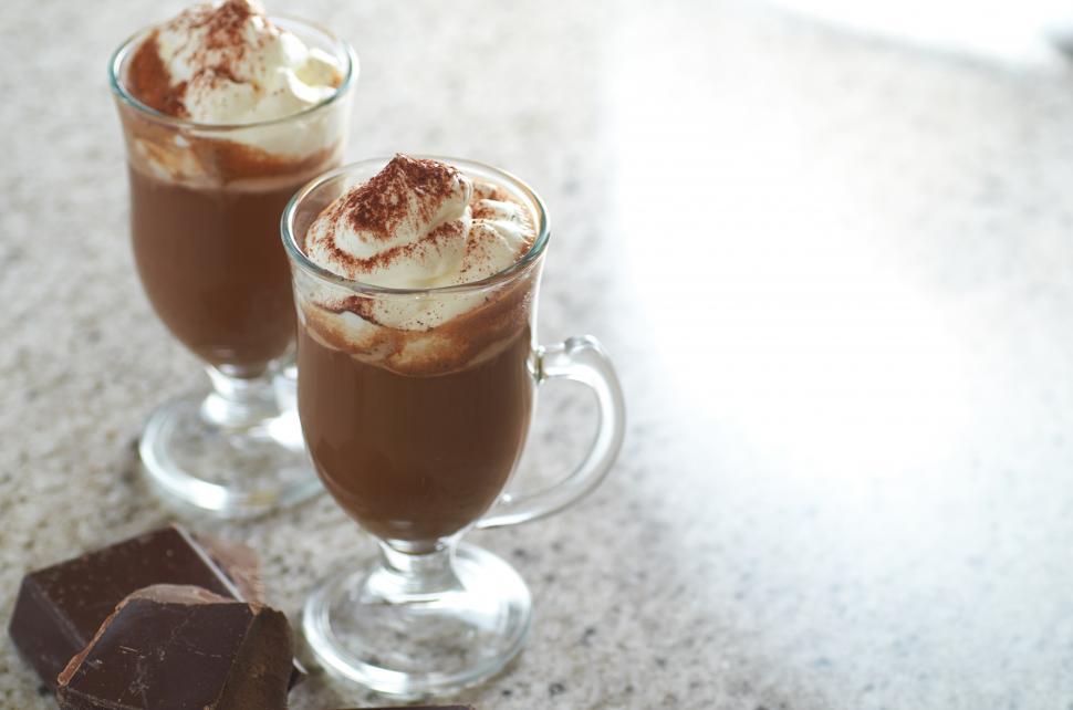 Free Image of Two glasses of chocolate drink with whipped cream and chocolate bars 