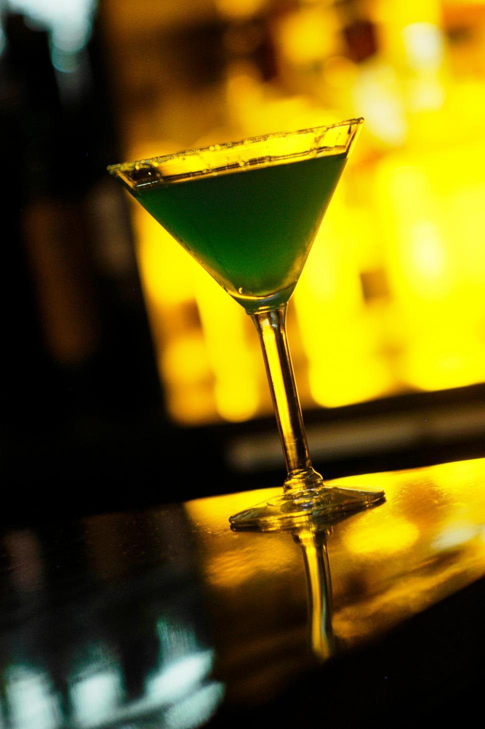 Free Image of A glass with a green cocktail in it 