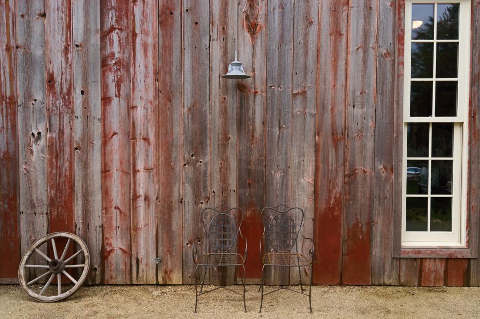 Free Image of Two chairs outside a barn 