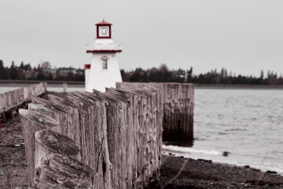 Free Image of A wooden fence next to a lighthouse 