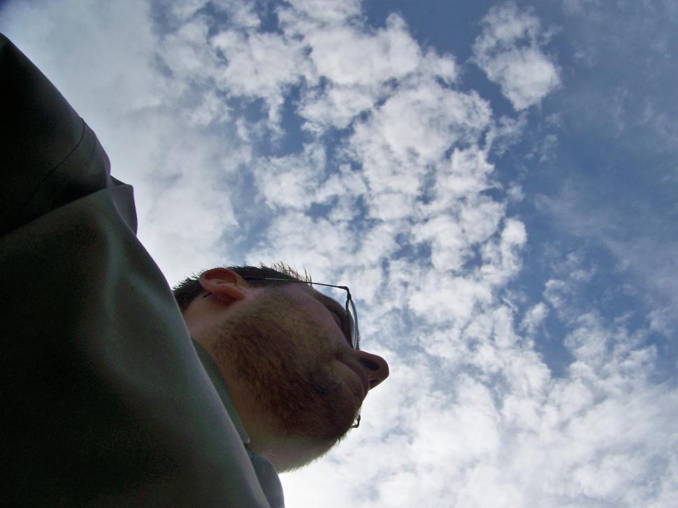 Free Image of Man Gazing Up at Sky With Clouds 