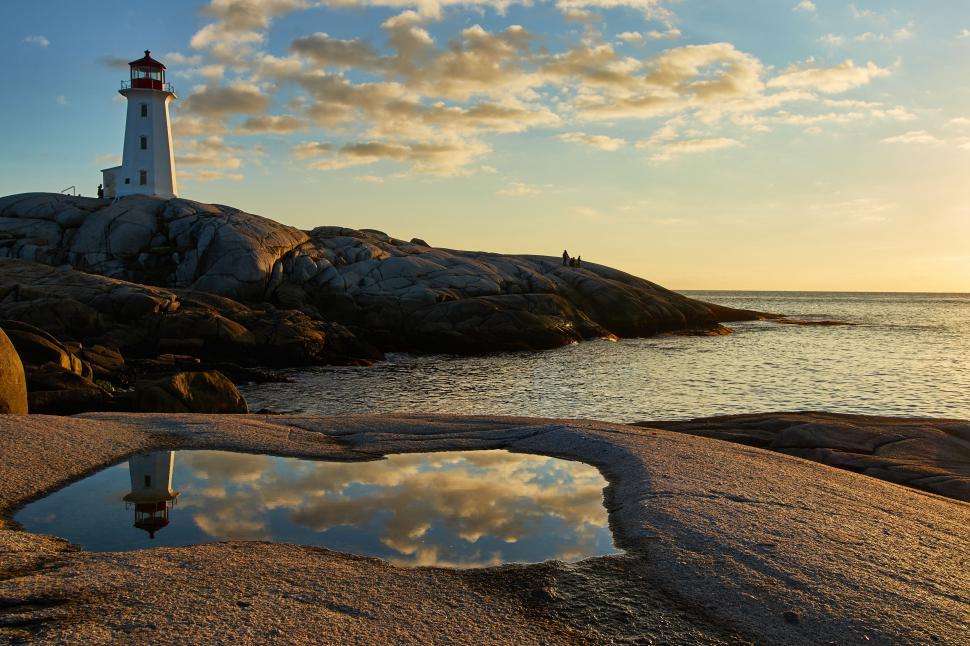 Free Image of A lighthouse on a rocky beach 