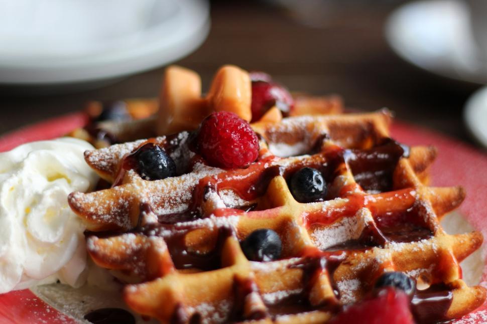 Free Image of A waffle with berries and whipped cream 