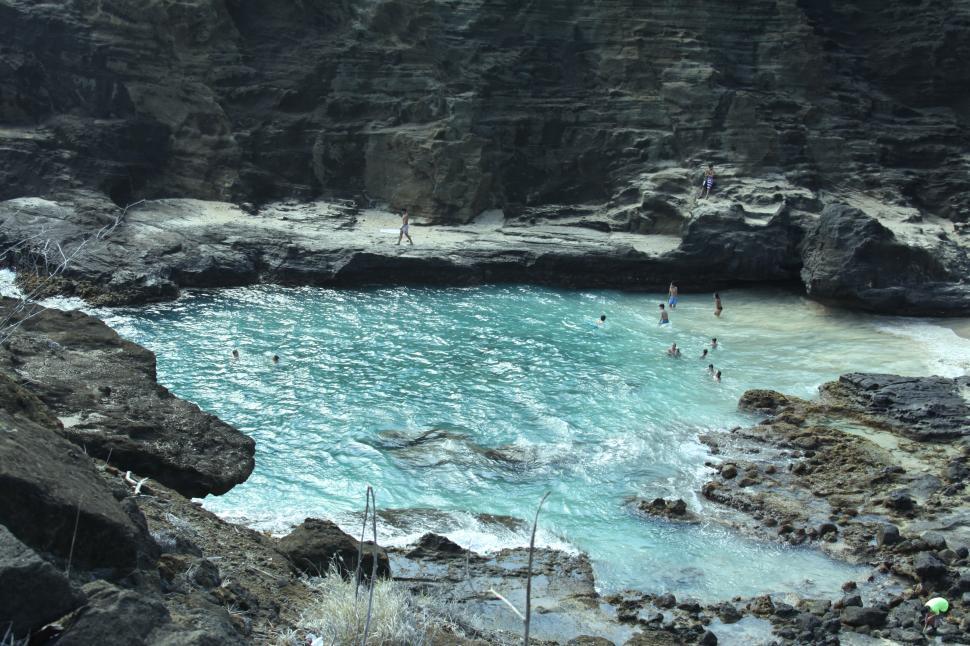 Free Image of A group of people swimming in a natural pool in Hawaii 