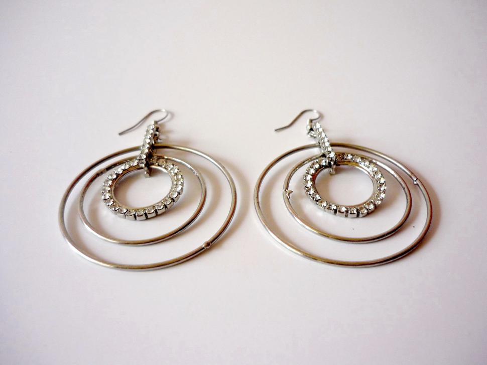 Free Image of Elegant Silver Hoop Earrings on White Surface 