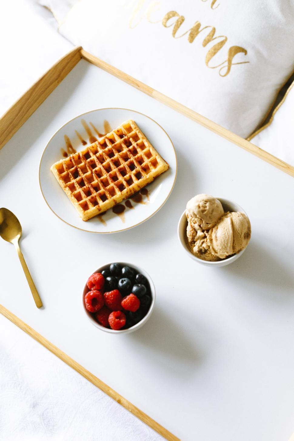 Free Image of A plate of waffles and ice cream with berries on a white tray 