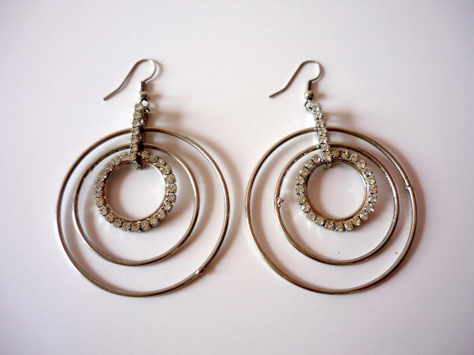 Free Image of Shiny Silver Hoop Earrings on White Background 