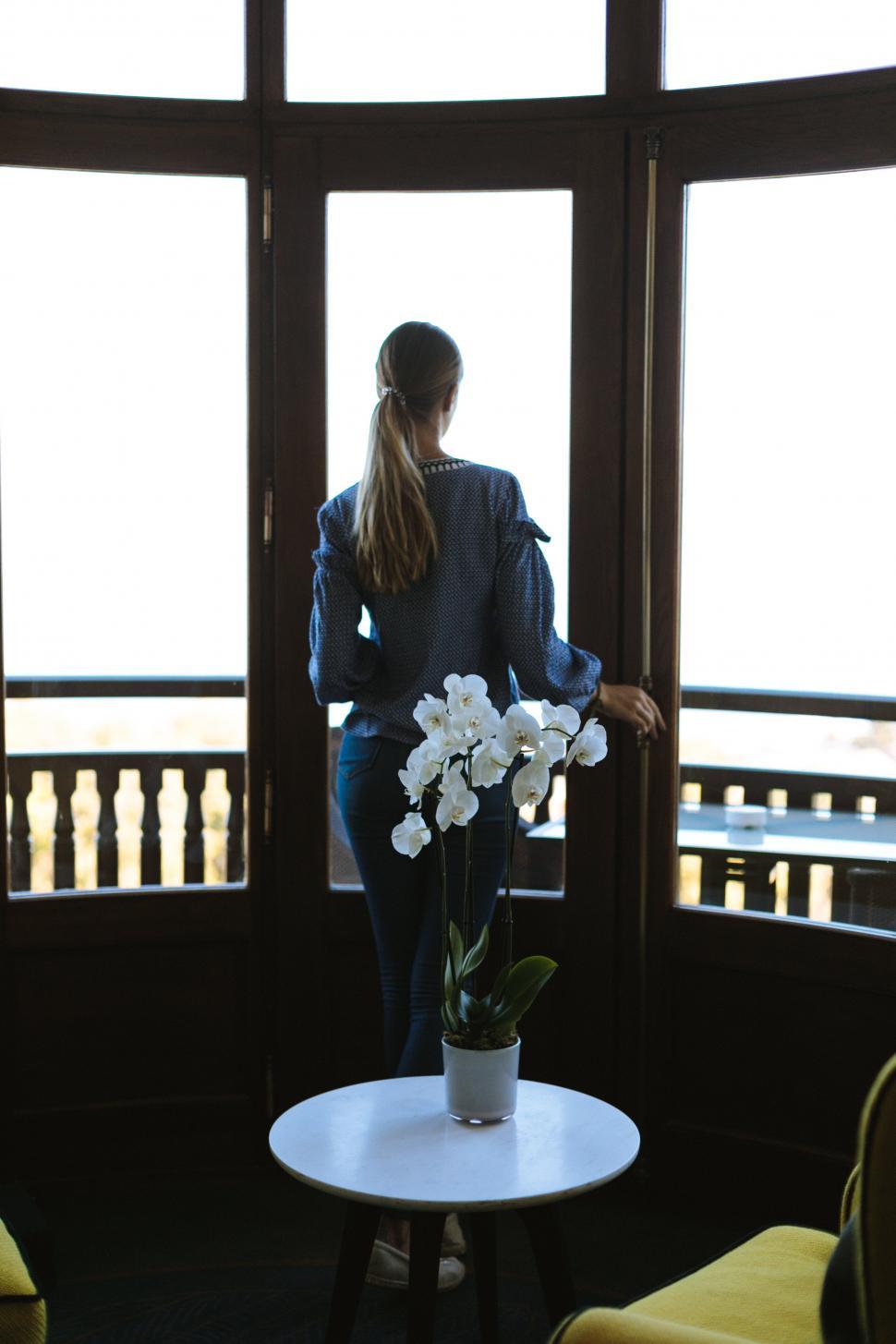 Free Image of A woman standing in front of a window 