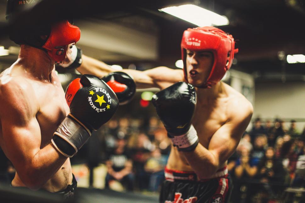 Free Image of Two men wearing boxing gloves and helmets 