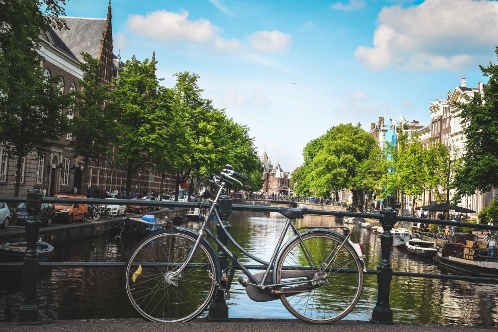 Free Image of A bicycle on a bridge over water 