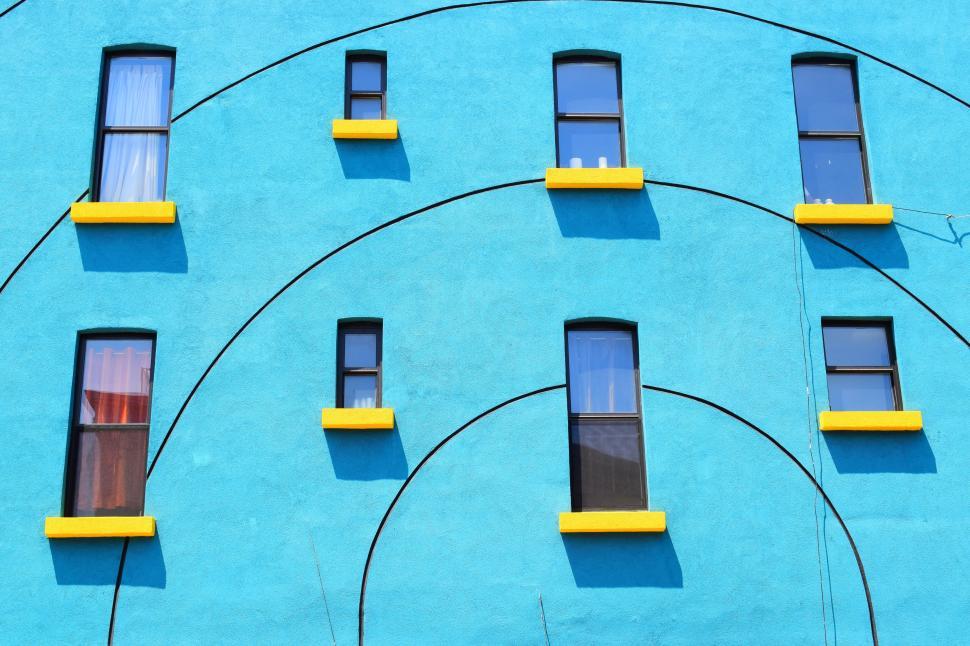 Free Image of A blue building with many windows 