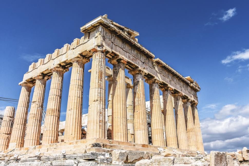 Free Image of A stone structure with columns with parthenon in the background 