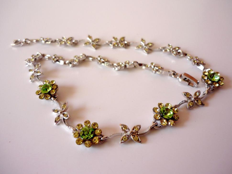 Free Image of Necklace With Flowers on a White Surface 