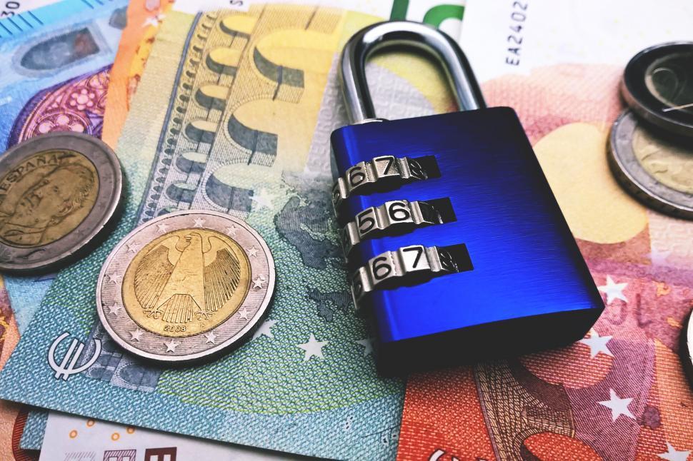 Free Image of A padlock on a pile of money 