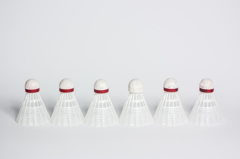 Free Image of A row of shuttlecocks on a white surface 