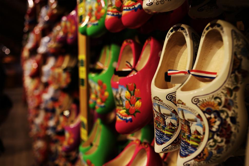 Free Image of A group of colorful clogs on a shelf 