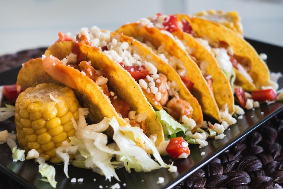 Free Image of A row of tacos on a black plate 