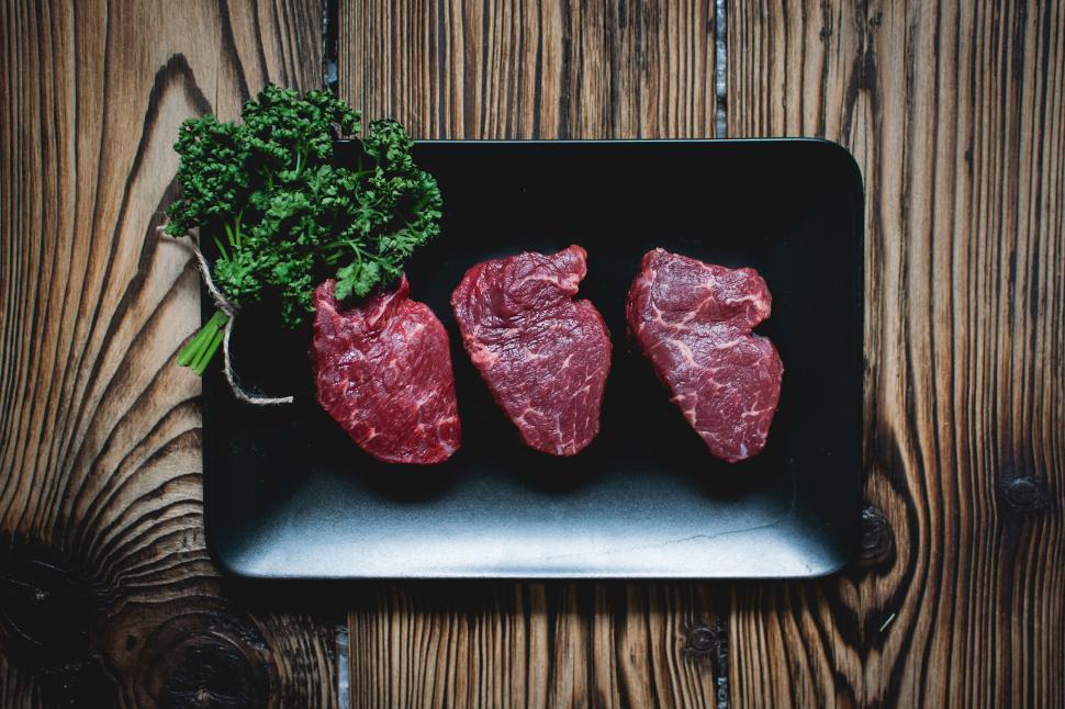 Free Image of A black plate with meat and parsley on it 