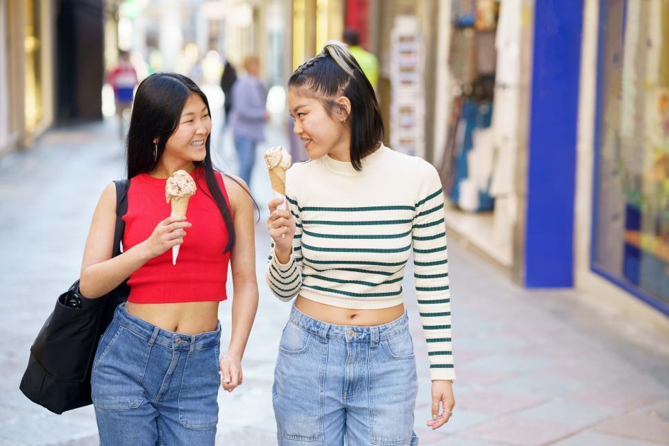 Free Image of Cheerful Asian women with ice cream in street 