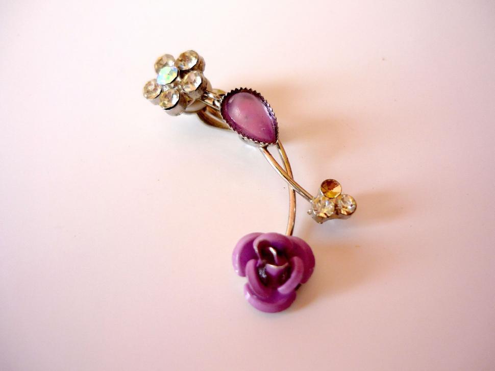 Free Image of Purple Flower Brooch on White Table 