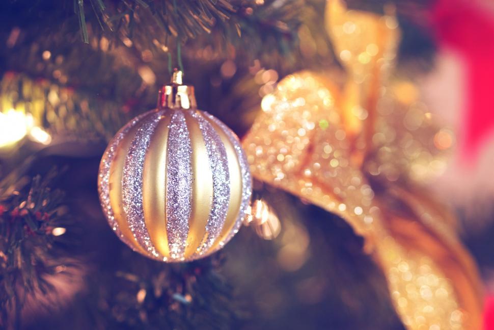 Free Image of A gold and silver ornament on a christmas tree 