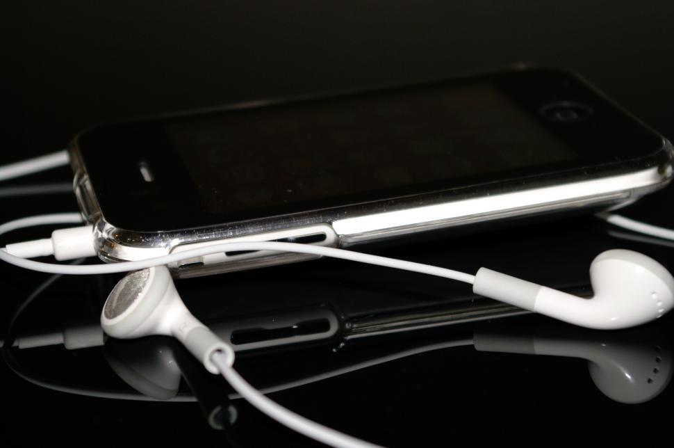 Free Image of Cell Phone and Earphones on Table 