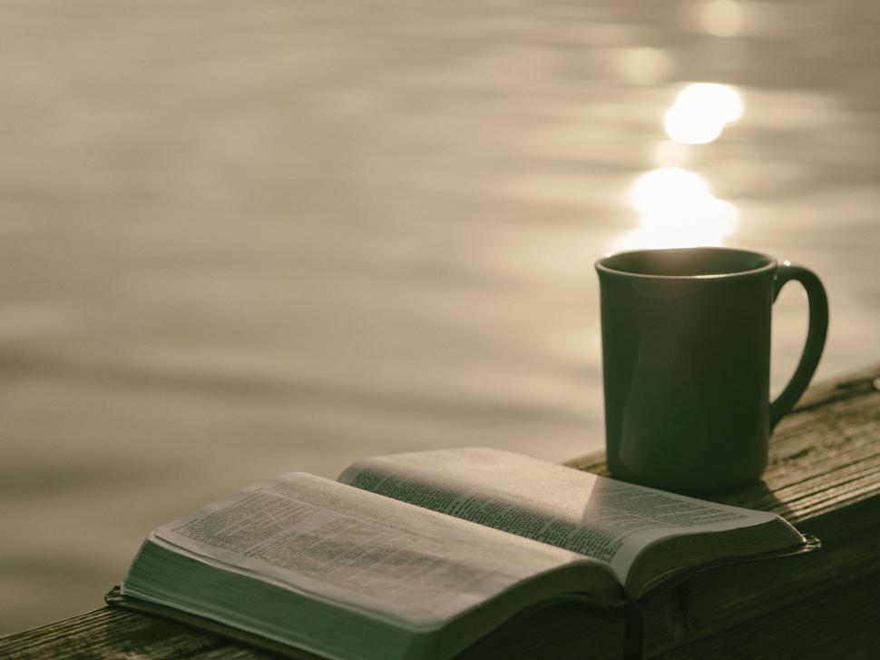Free Image of A book and a mug on a wood surface 