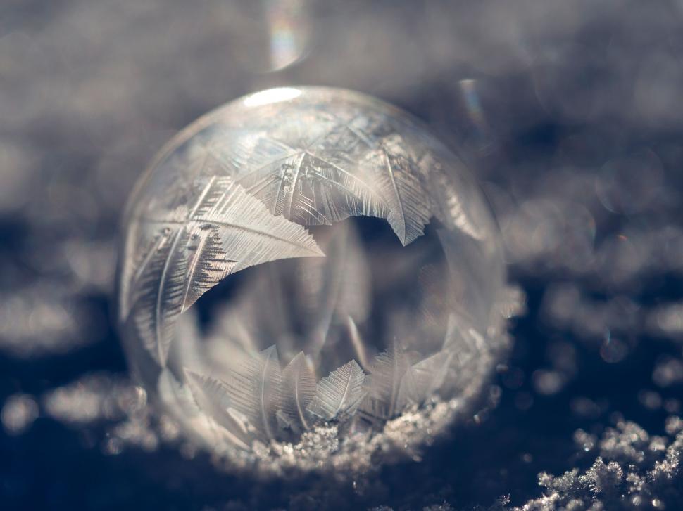 Free Image of A frozen bubble with ice crystals on it 