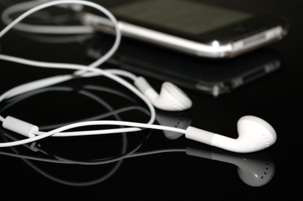 Free Image of Headphones and Cell Phone on Table 