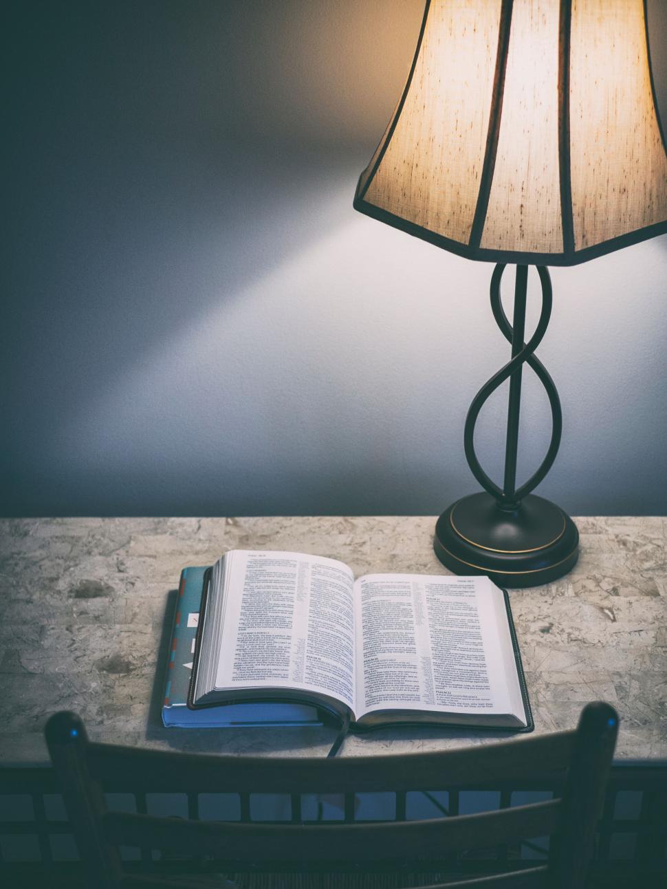 Free Image of A book on a table with a lamp 