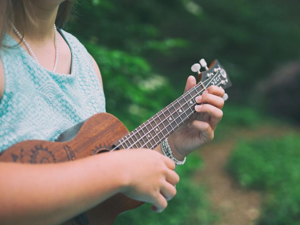 Free Image of A person playing a ukulele 