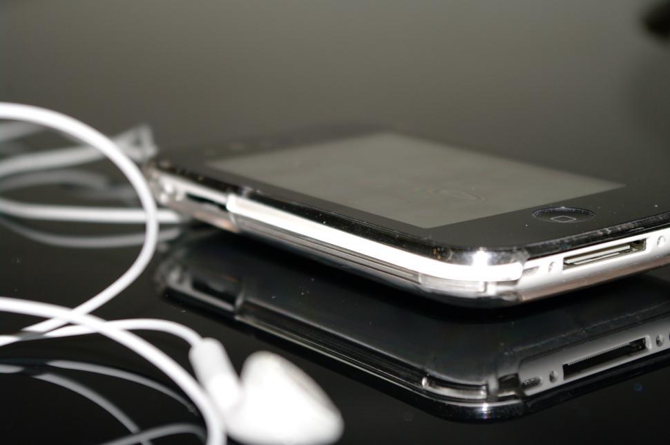 Free Image of Cell Phone and Earphones on Table 