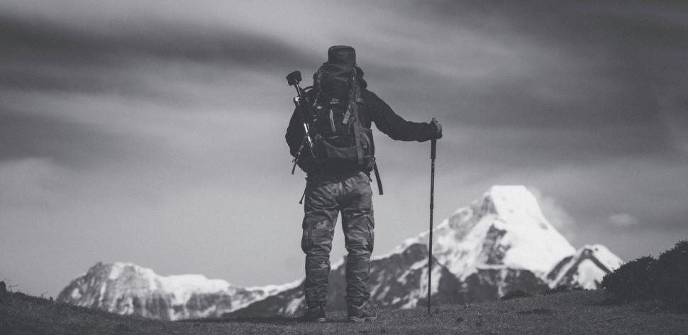 Free Image of A person with backpack and poles on a mountain 