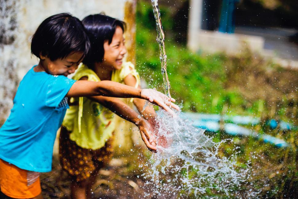 Free Image of Two children playing with water 