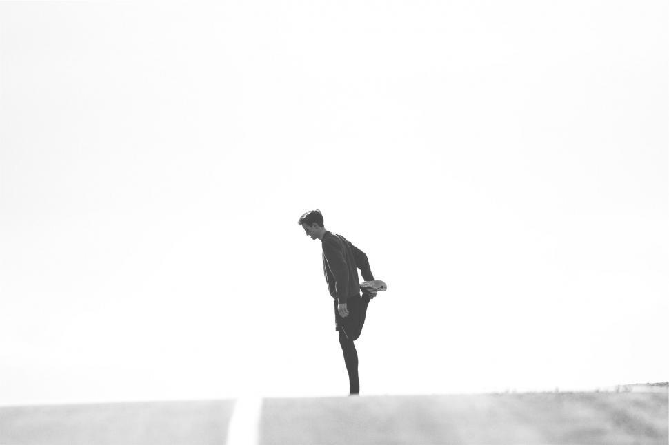 Free Image of A man standing on one leg 