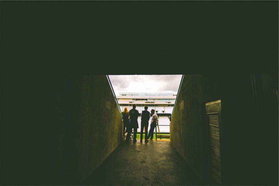 Free Image of A group of people standing in a tunnel 