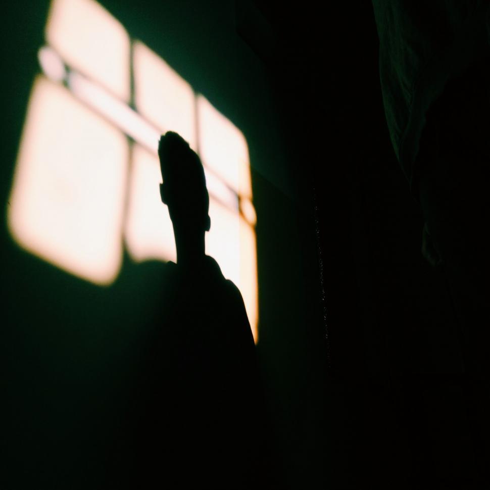 Free Image of A person s head in a dark room 