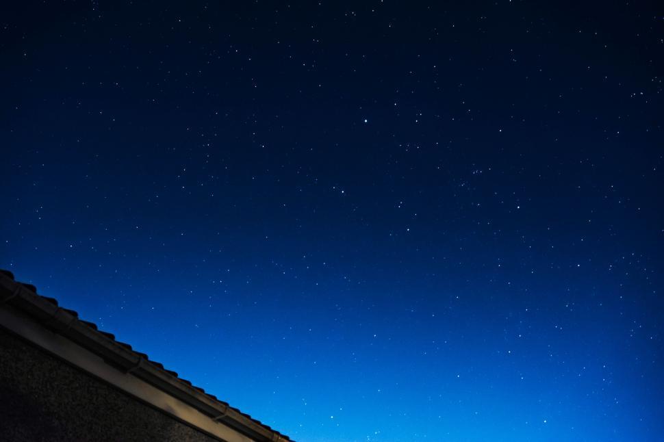 Free Image of A roof top of a building with stars in the sky 