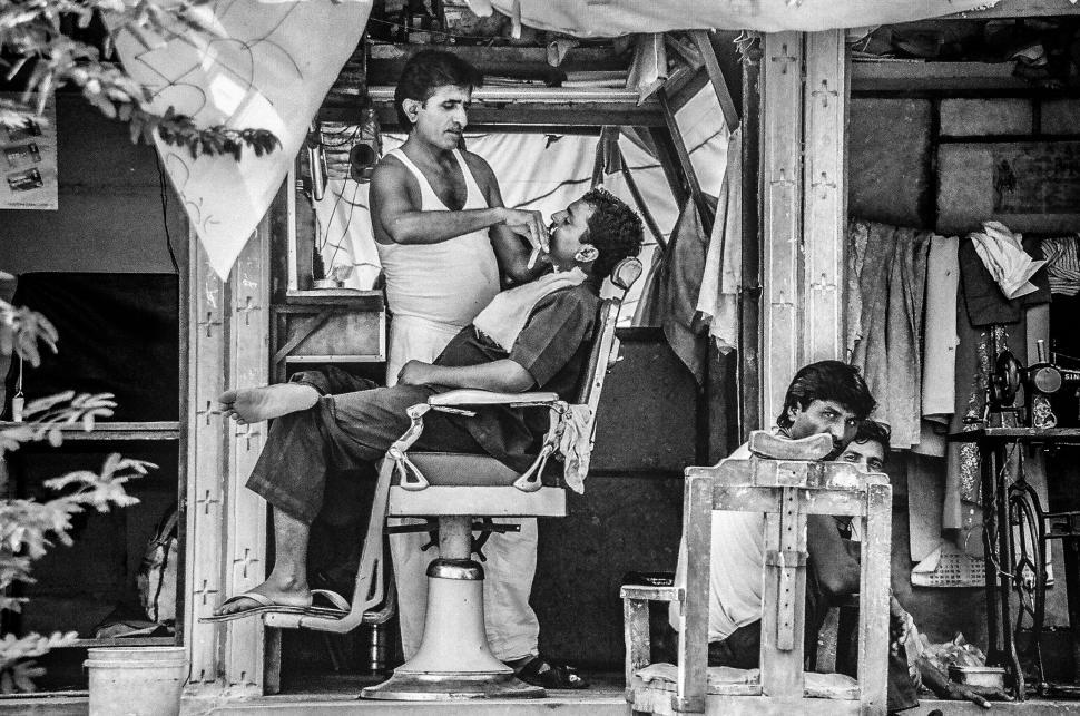 Free Image of A man getting a haircut of a man in a barber shop 