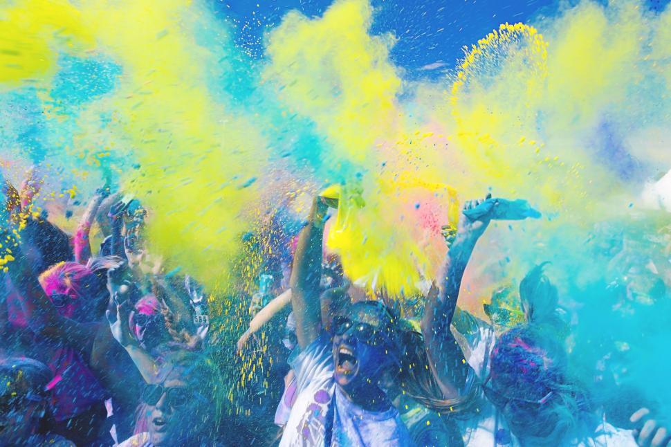 Free Image of A group of people throwing colorful powder 