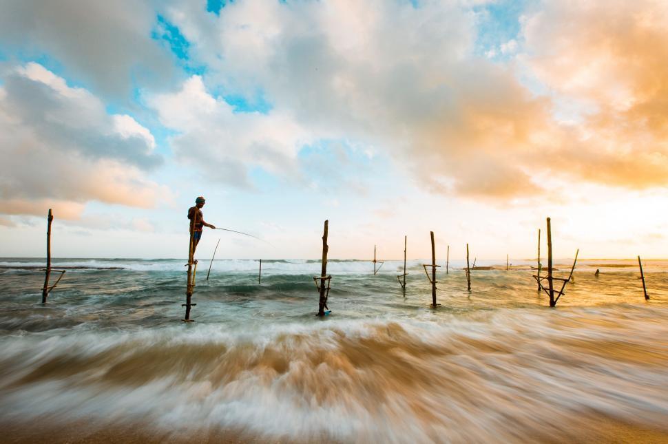 Free Image of A man fishing in the ocean 