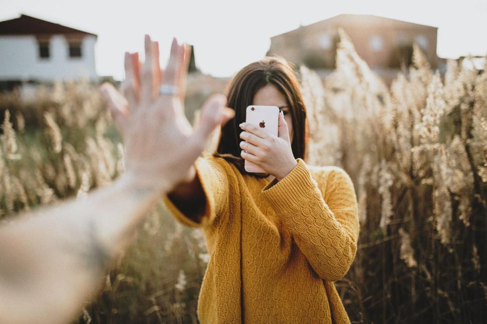Free Image of A woman taking a selfie in a field 