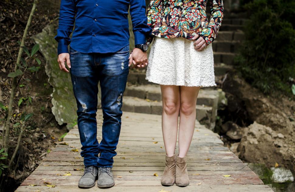 Free Image of A man and woman holding hands 