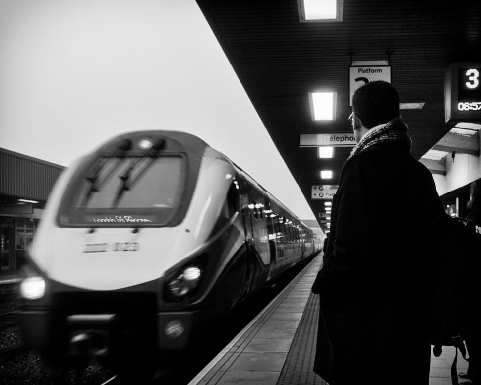 Free Image of A man standing at a train station 