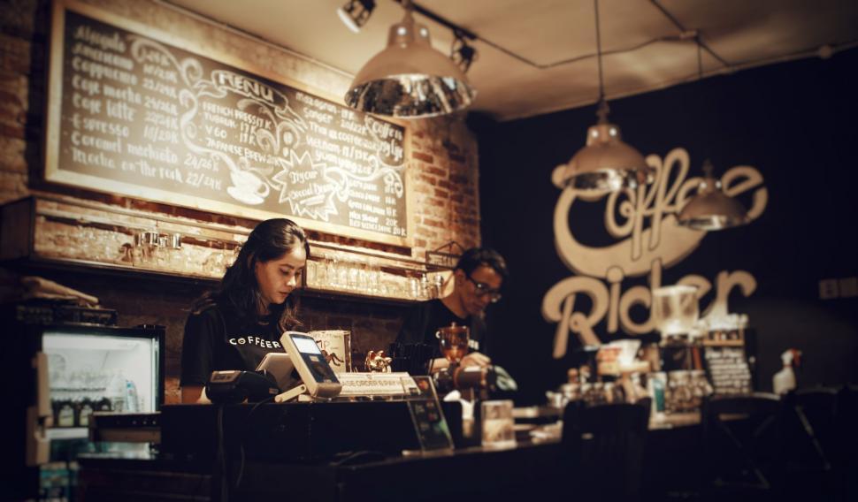 Free Image of A woman at a counter in a coffee shop 