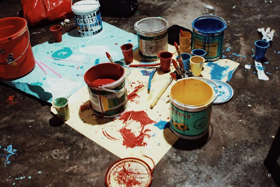 Free Image of Paint cans and brushes on a floor 