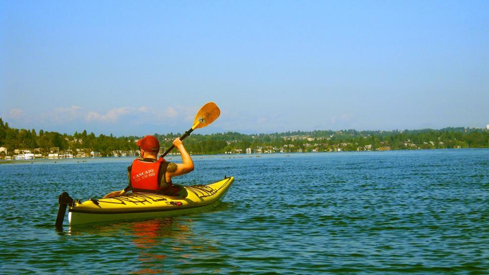 Free Image of A man in a kayak on a lake 