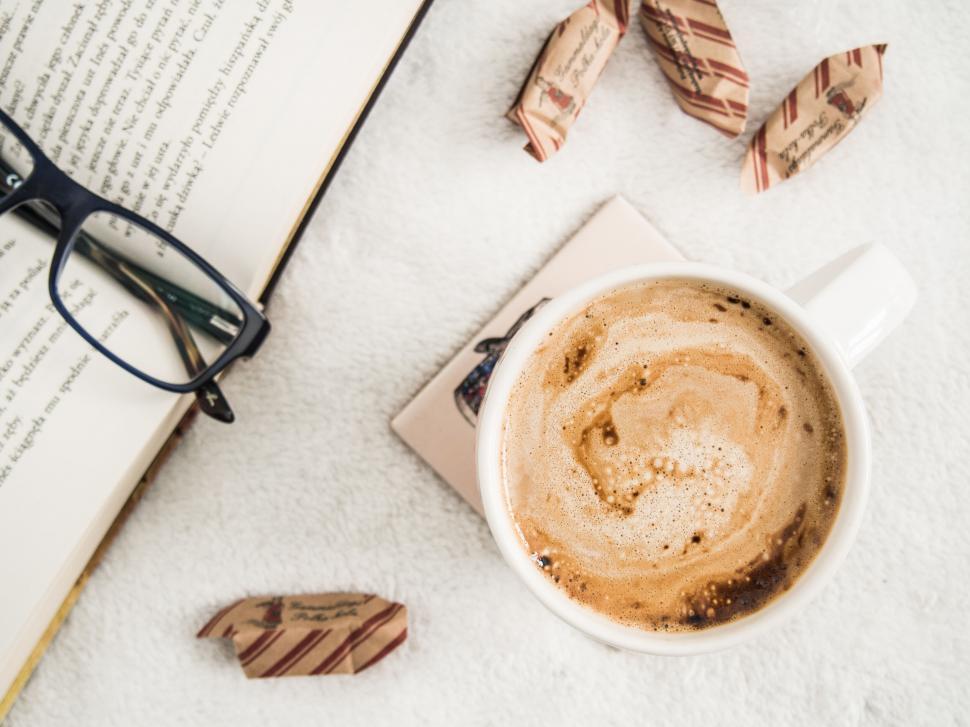Free Image of A cup of coffee and a book 